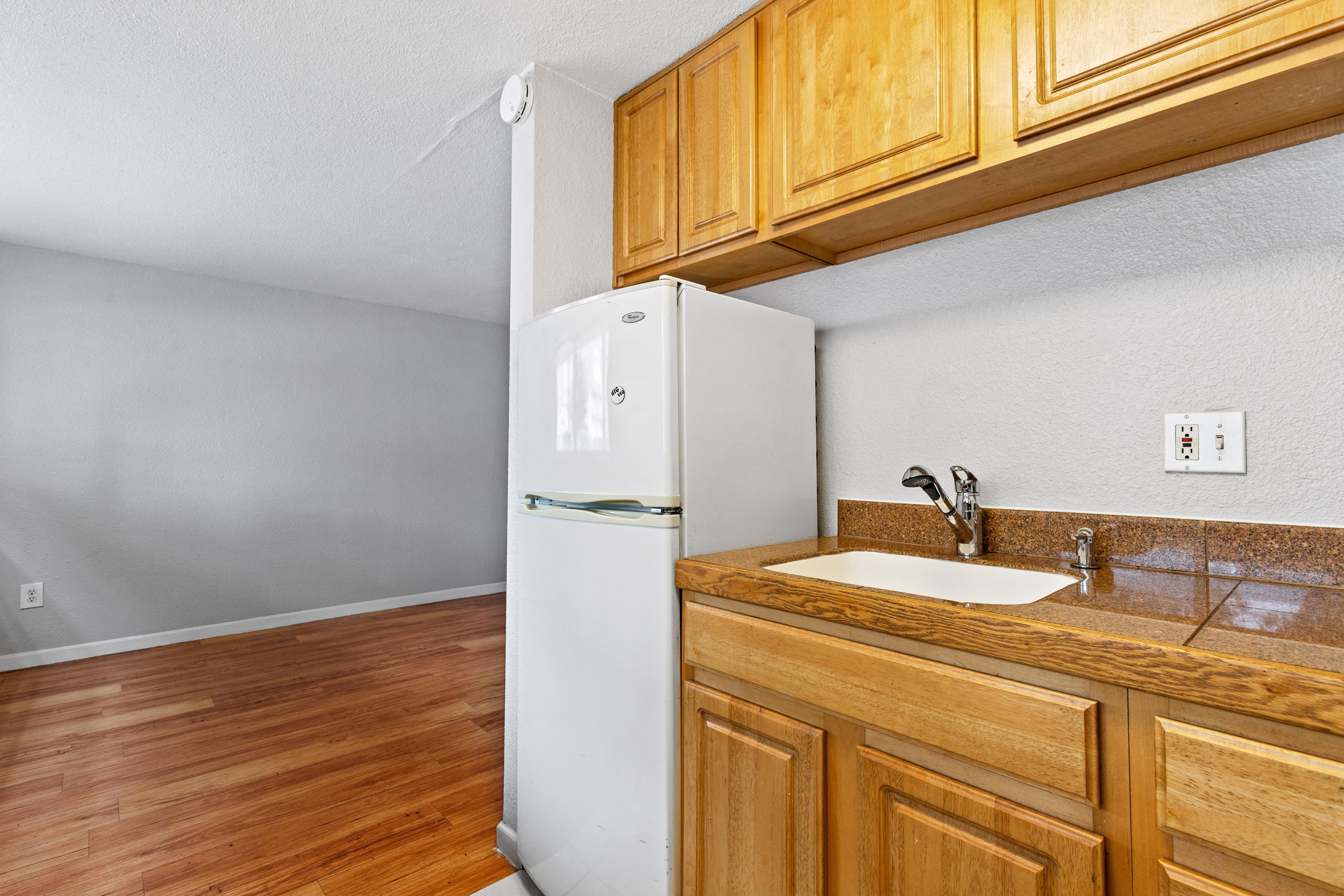 a kitchen with a sink and a refrigerator